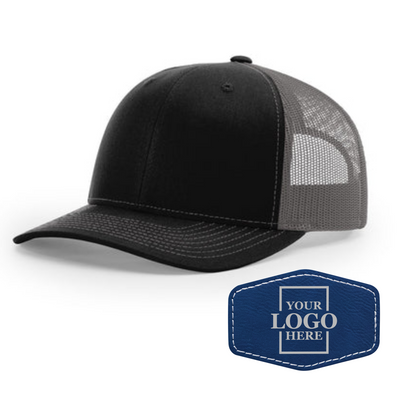 Realtor branded black and charcoal trucker snapback hat with a blue hex patch with silver engraving