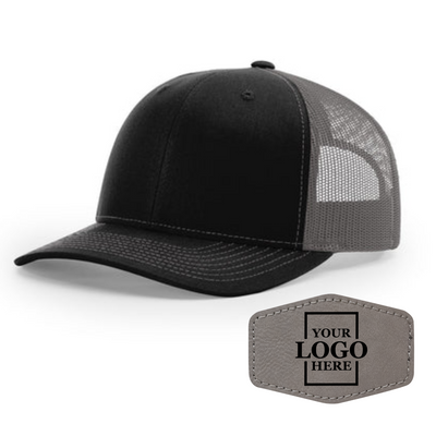 Realtor branded black and charcoal trucker snapback hat with a gray hex patch with black engraving