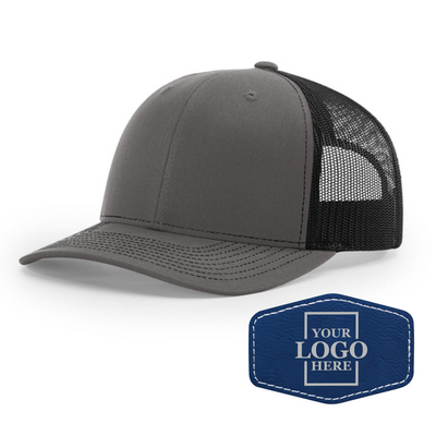 Realtor branded charcoal and black trucker snapback hat with a blue hex patch with black engraving