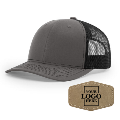 Realtor branded charcoal and black trucker snapback hat with a light brown hex patch with black engraving