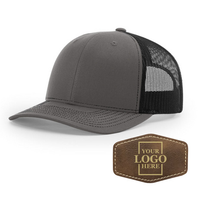 Realtor branded charcoal and black trucker snapback hat with a rustic hex patch with gold engraving