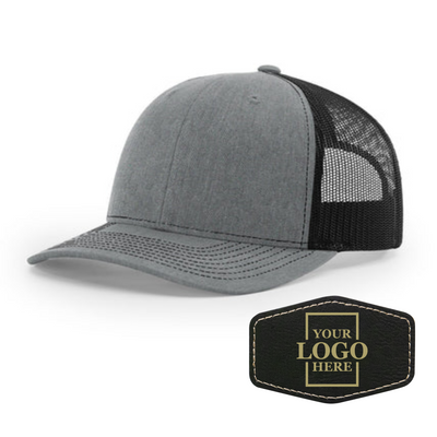 Realtor branded gray and black trucker snapback hat with a black hex patch with gold engraving