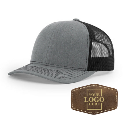 Realtor branded gray and black trucker snapback hat with a rustic hex patch with gold engraving
