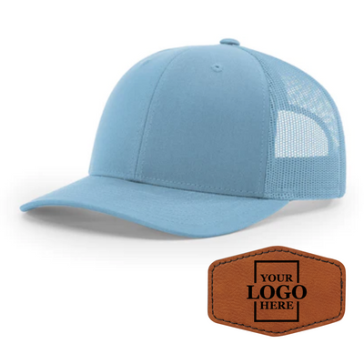 Realtor branded light blue trucker snapback hat with a rawhide hex patch with black engraving