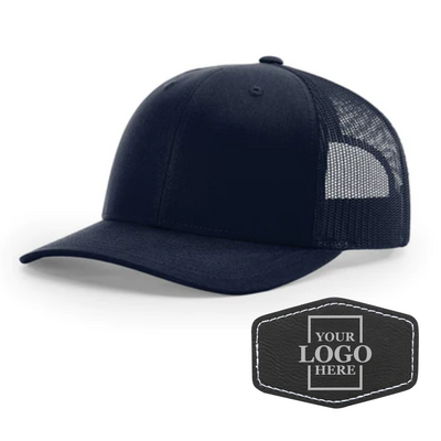 Realtor branded navy trucker snapback hat with a black hex patch with silver engraving