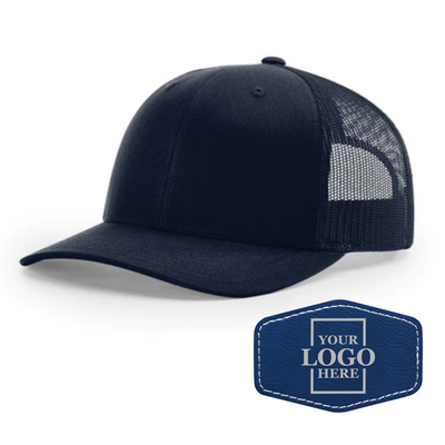 Realtor branded navy trucker snapback hat with a blue hex patch with silver engraving