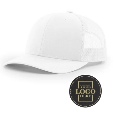 Realtor branded white trucker snapback hat with a round black patch with gold engraving