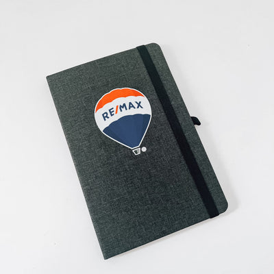 Realtor promotional branded canvas journal in black showcasing RE/MAX logo