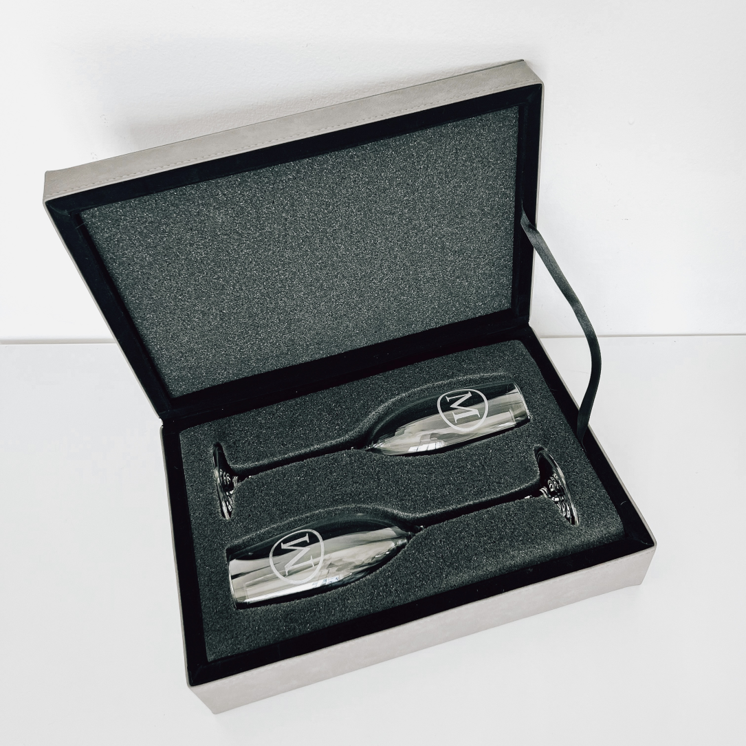 Real estate closing gift of glass champagne flutes with leatherette box gray with black engraved, shown inside with flutes engraved in design 2