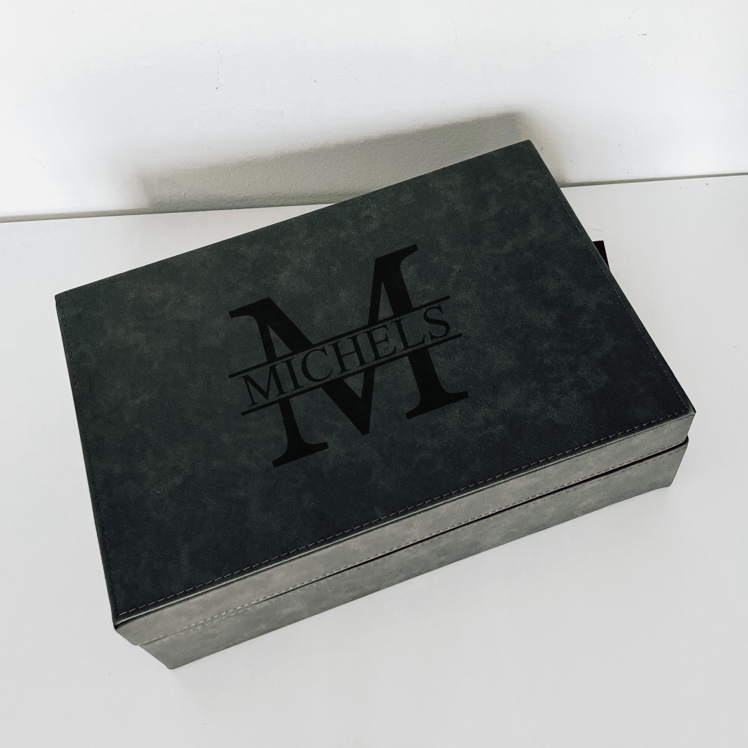 Real estate closing gift of glass champagne flutes with leatherette box gray with black design 1 engraved, shown top view