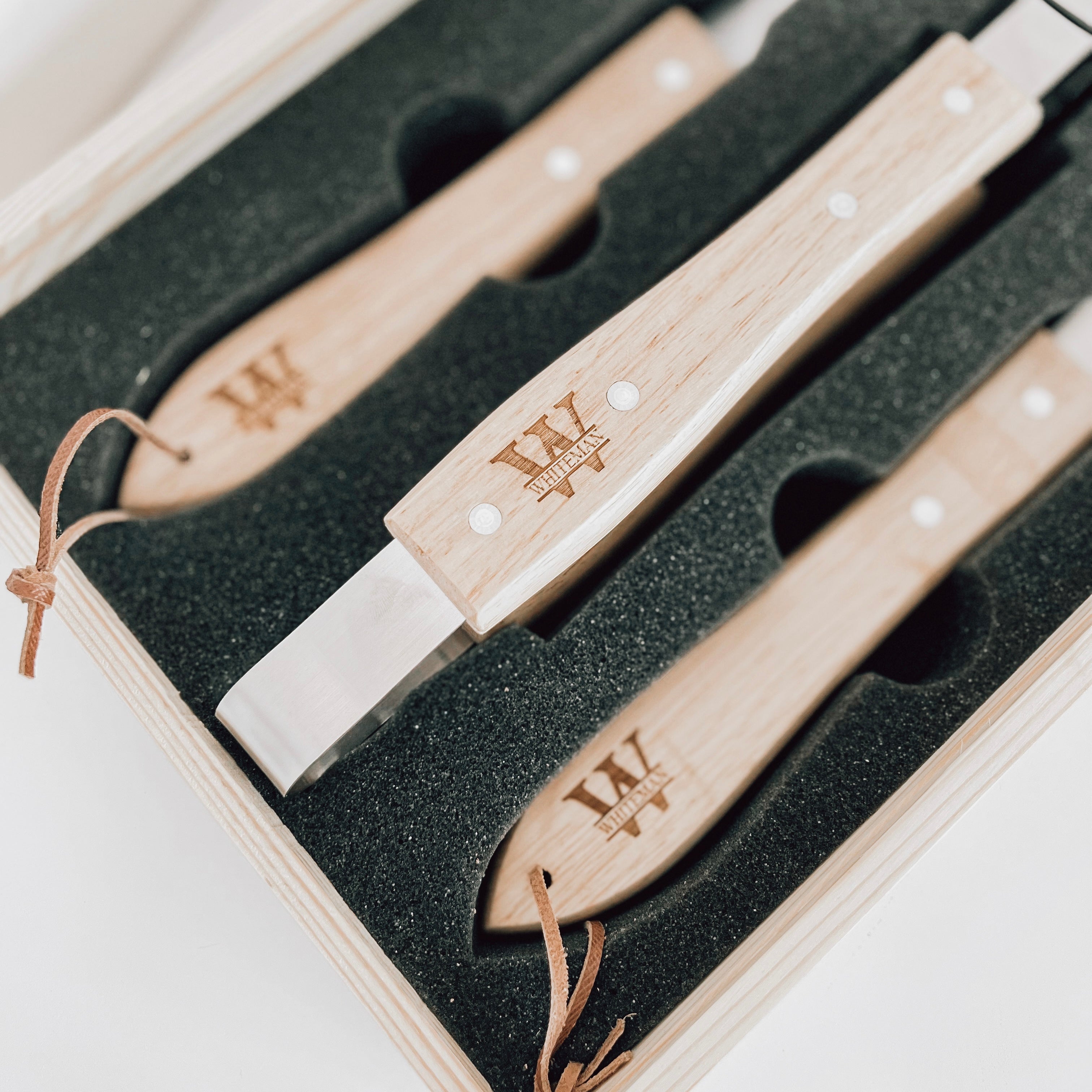 Real estate gift of grill set showing the inside with the tools engraved in split monogram design with last name