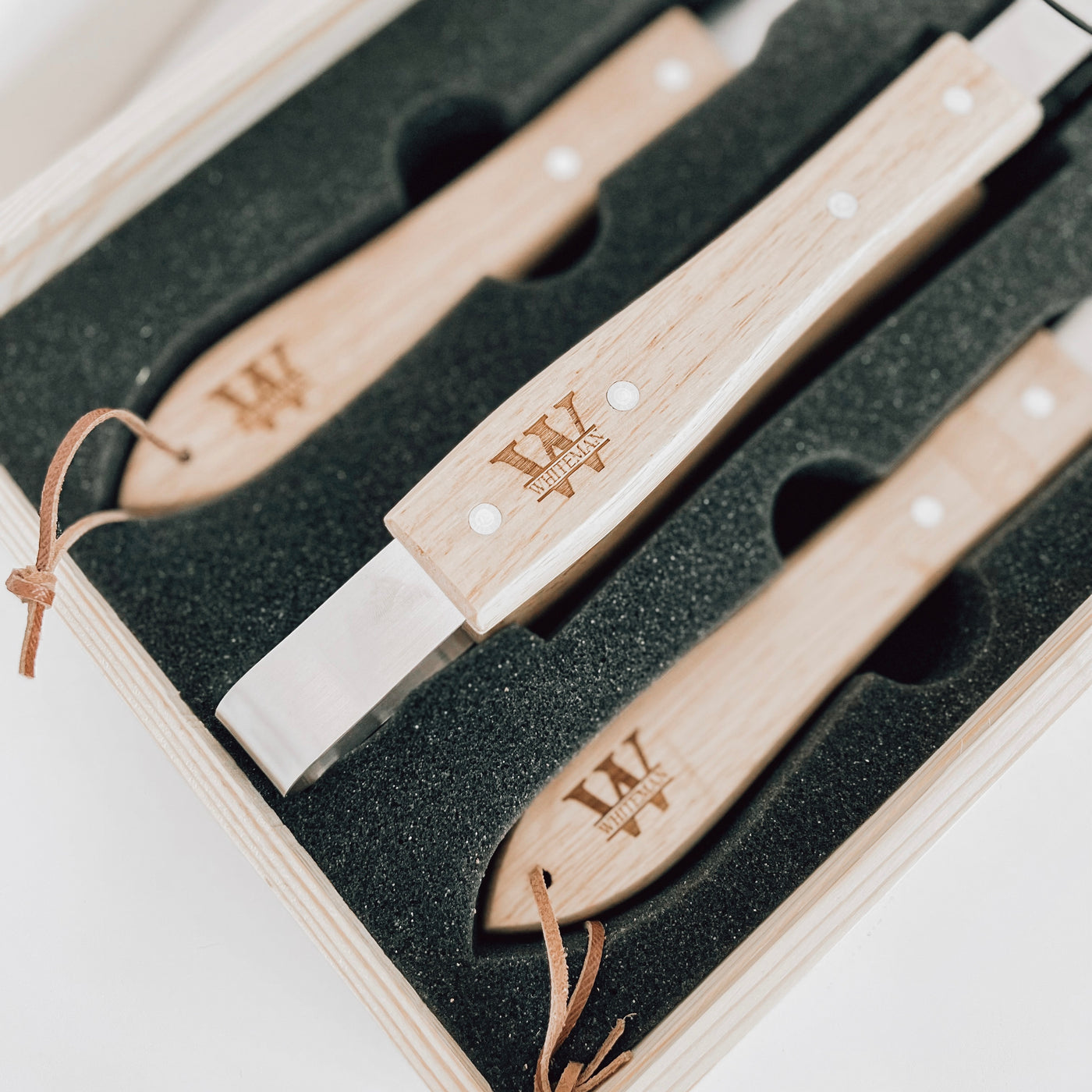 Real estate gift of grill set showing the inside with the tools engraved in split monogram design with last name