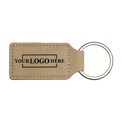 Realtor promotional light brown branded leatherette keychains with black engraving, shown horizontally