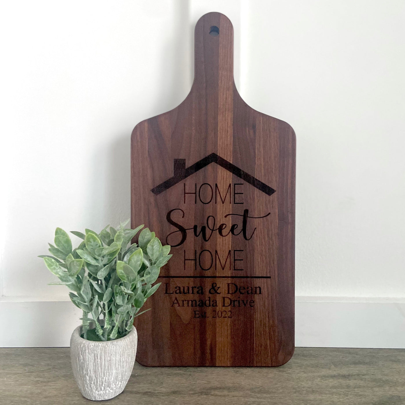 Real estate gift of a large maple paddle cutting board with home sweet home design