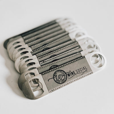 Real estate gift of bulk branded leatherette bottle opener in gray with black engraving