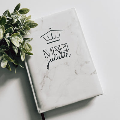 Real estate promotional gift of a marble leatherette notepad engraved with black