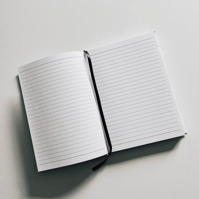 Real estate promotional gift of a marble leatherette notepad showing inside of notepad