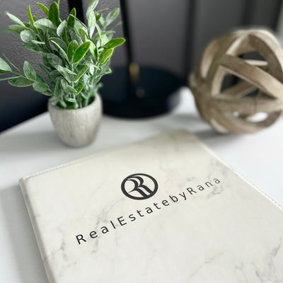 Real estate promotional gift of a marble leatherette portfolio with notepad engraved with black 