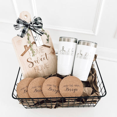 Real estate closing gift rubber wood basket 2 which includes a medium rubber wood cutting board, cork coasters, and 2 20 oz tumblers