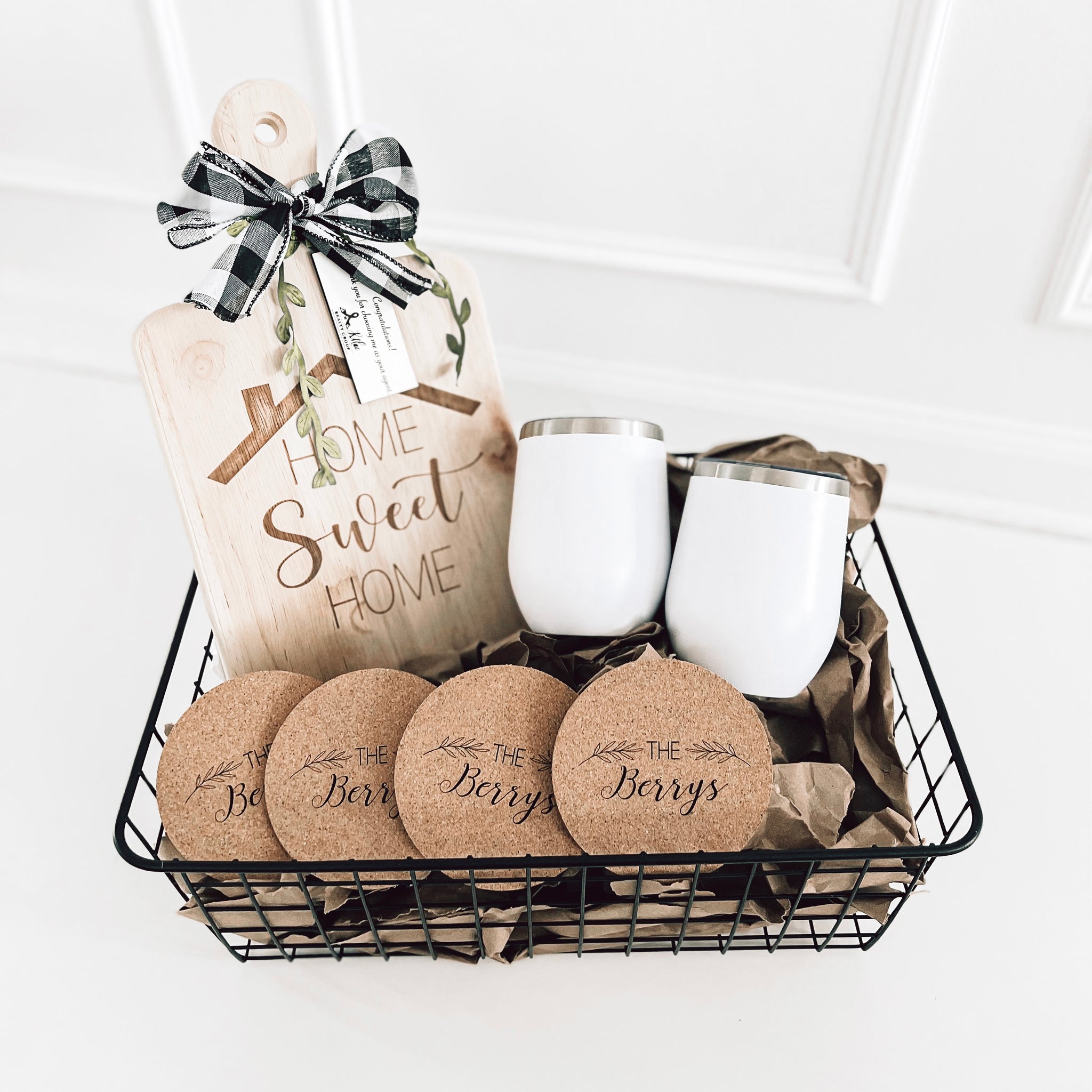 Real estate closing gift rubber wood basket 2 which includes a medium rubber wood cutting board, cork coasters, and 2 12 oz wine tumblers