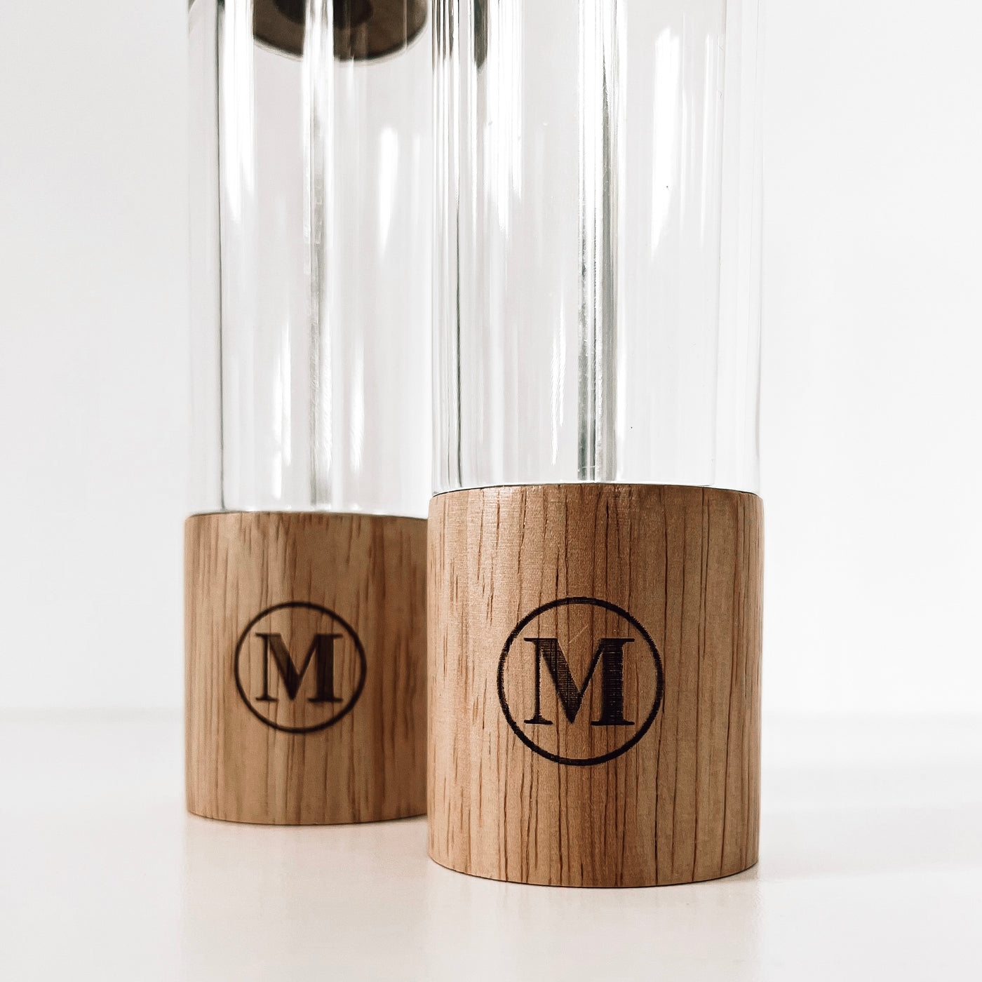 Real estate gift of salt and pepper shakers with design 1 of last initial in a circle zoomed in