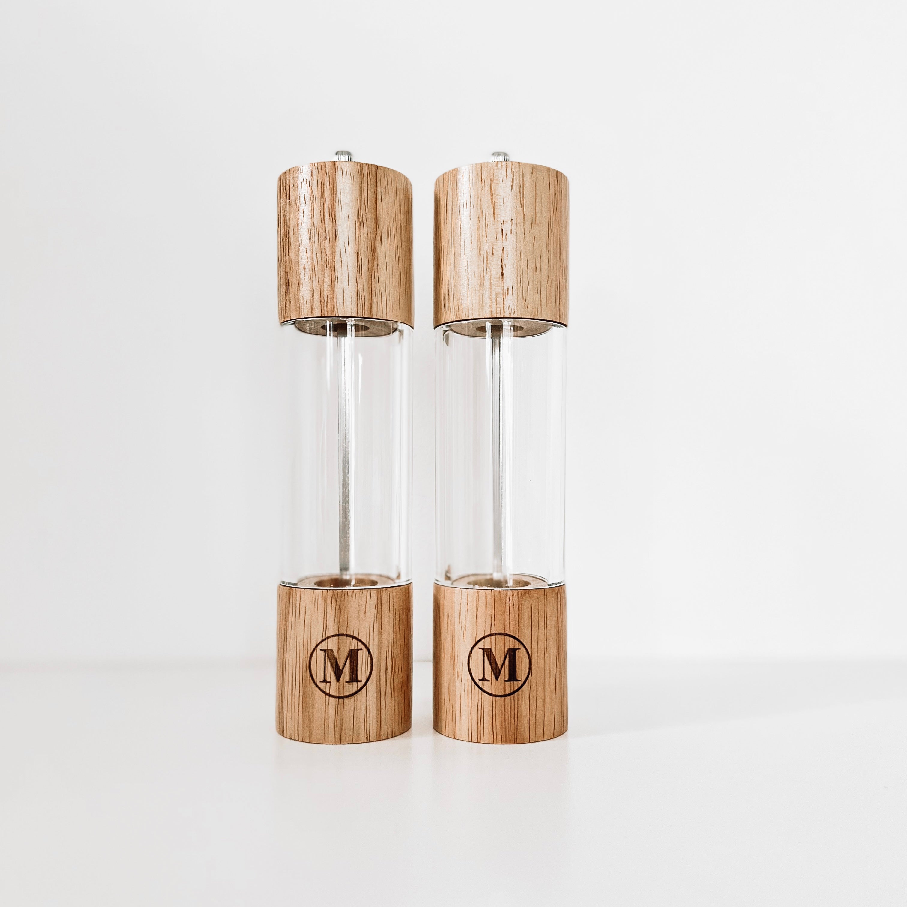 Real estate gift of salt and pepper shakers with design 1 of last initial in a circle