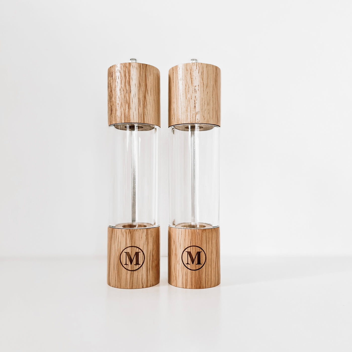 Real estate gift of salt and pepper shakers with design 1 of last initial in a circle