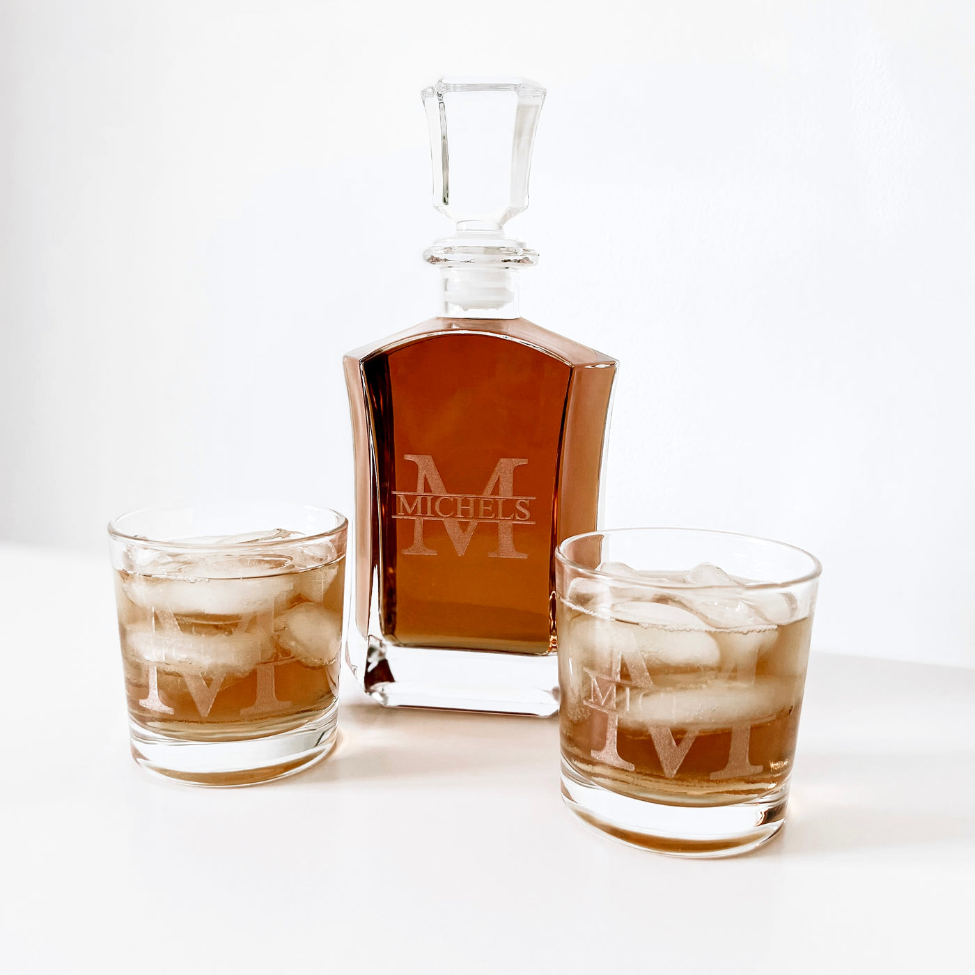 Real estate gift of custom whiskey decanter with last name split monogram design with matching 10.5 oz rocks glasses