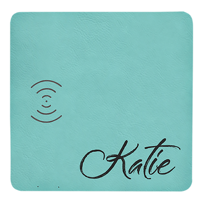 Real estate promotional gift of a teal branded leatherette wireless charging mat engraved in black 